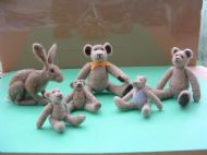 Five needlefelted rabbits and a hare.